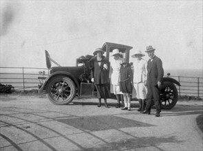 A group of people in front of their car at the seaside, c1920s(?). Artist: Unknown