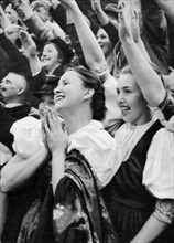 Admiring crowd saluting German Nazi leader Adolf Hitler, 1938. Artist: Unknown
