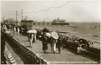 Pier, promenade and bandstand, Eastbourne, Sussex, c1920s(?). Artist: Unknown