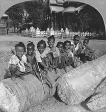 Burmese children sitting on a palm log, Burma, 1908. Artist: Stereo Travel Co