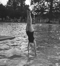 Woman diving into a swimming pool, 20th century. Artist: Unknown