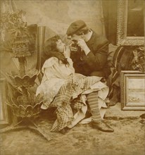 Couple lighting a cigarette from each other, 1900. Artist: Unknown