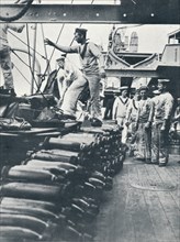 Receiving shells for the naval guns on the deck of a battleship, c1914. Artist: Unknown