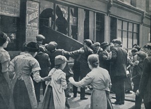 Anti-German rioting in London: A crowd breaking in the windows of a German shop', c1914. Artist: Unknown