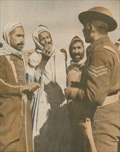 'Tunisian Arabs Welcome a British Sergeant at Chaouach', 1943. Artist: Unknown.