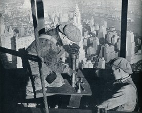 'Rivetting the last bolts on The Morning Mast of the Empire State building', c1931. Artist: Lewis Wickes Hine.