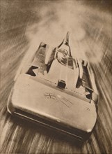 Sir Malcolm Campbell at high speed in `Blue Bird`, 1935. Artist: Unknown.