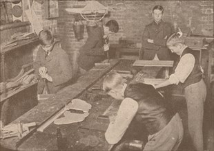 Boys of Harrow School making splints, crutches and other articles for the wounded, c1916 (1928). Artist: Unknown.