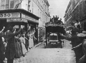 'British troops receive a welcome as they arrive by motor van in a French town', 1915. Artist: Unknown.