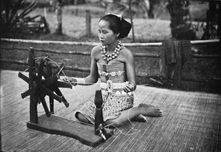 A Dayak girl at her spinning wheel, 1902. Artist: Unknown.