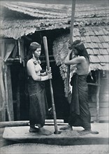 Kenyah women pounding rice, Sarawak, 1902. Artist: Dr Charles Hose.