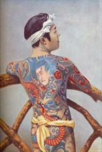 An elaborately tattooed Japanese man, 1902. Artist: Unknown.