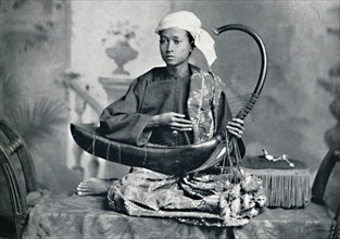 Burmese harp player, 1902. Artist: Unknown.