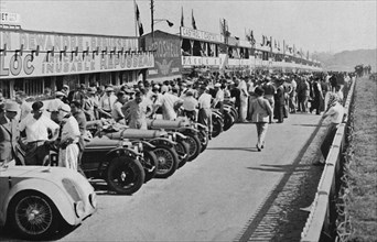 'The busy pits: before the start of Le Mans 24-hour Race', 1937. Artist: Unknown.