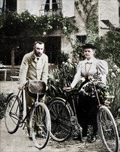 Pierre and Marie Curie, French physicists, preparing to go cycling. Artist: Unknown.