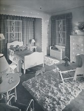 'Nursery by W. & J. Sloane, with cream-coloured furniture and shaggy white rugs on a blue painted fl Artist: Unknown.