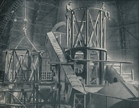 'Section By Section Mounts The Huge Steel Framework of the Hooker's Cylinder', c1935. Artist: Unknown.