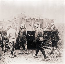 Soldiers walking behind tank, c1914-c1918.  Artist: Unknown.