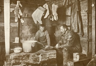 'Meares and Demetri at the Blubber Stove in the 'Discovery' Hut', 3 November 1911, (1913). Artist: Herbert Ponting.