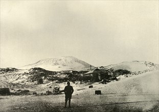 'The Hut, with Mount Erebus in the Background, in the Autumn', 1908, (1909).  Artist: Unknown.