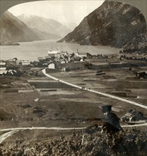 'Village roofs and sunny fields of Odde, N. up the narrow mountain-walled Sorfjord, Norway', 1905. Creator: Unknown.