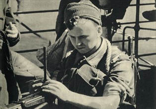 Royal Marine checking his machine gun, World War II, c1939-c1943 (1944). Creator: Unknown.