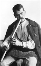 Man playing a wind instrument, Bistrita Valley, Moldavia, north-east Romania, c1920-c1945. Artist: Adolph Chevalier