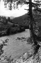 Floating tree trunks down the river, Bistrita Valley, Moldavia, north-east Romania, c1920-c1945. Artist: Adolph Chevalier