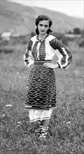 Young woman in traditional dress, Bistrita Valley, Moldavia, north-east Romania, c1920-c1945. Artist: Adolph Chevalier