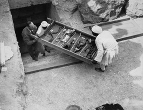 Removing a tray of chariot parts from the Tomb of Tutankhamun, Valley of the Kings, Egypt, 1922. Artist: Harry Burton