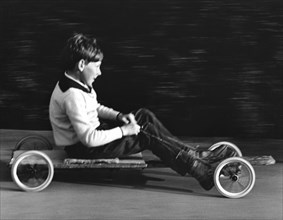 Boy driving a home-made go-kart, Horley, Surrey, 1965.
