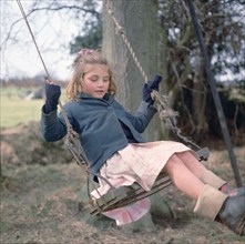 Young gipsy girl on a swing, Charlwood, Newdigate area, Surrey, 1964.