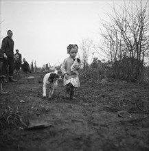 Gipsy child with a puppy, Lewes, Sussex, 1963.