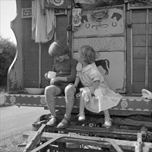 Children sitting on the steps of a gipsy caravan, Outwood, Surrey, 1963.