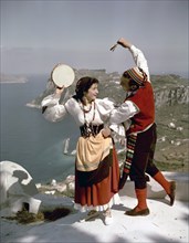Dancers perform a tarantella above the Bay of Naples, Isle of Capri, Italy, 1948. Artist: Göran Algård