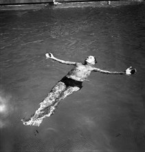A man takes a refreshing dip in a swimming pool during the hot summer, Sweden, 1943. Artist: Karl Sandels