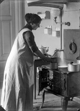 The photographer's wife in the kitchen, Landskrona, Sweden, 1910. Artist: Unknown
