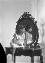 Posed portrait of a girl by a mirror, Landskrona, Sweden, 1910. Artist: Unknown