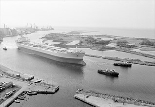 Tugboats assist the M/S 'Varenna' to leave Landskrona shipyard, Sweden, c1970. Artist: Unknown