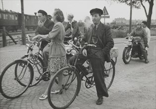 Cyclists by a level crossing, Landskrona, Sweden, 1950. Artist: Unknown