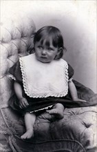 Portrait of a little girl in a big chair, c1910. Artist: Unknown