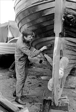 A man cleaning the keel of his sailing boat, Sweden, 1966. Artist: Unknown