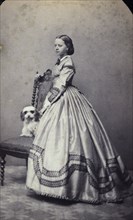 Studio portrait of an 18 year old girl in an ankle-length dress, c1856. Artist: Unknown