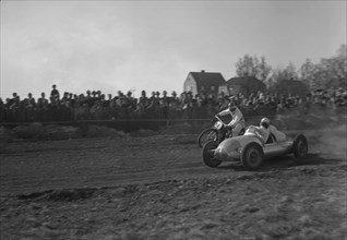 Car racing a motorbike on a dirt track, Arlöv, Scania, Sweden, 1947. Artist: Otto Ohm