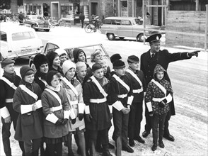A policeman teaches a group of schoolchildren how to be traffic officers, Sweden, c1956-1969(?). Artist: Unknown