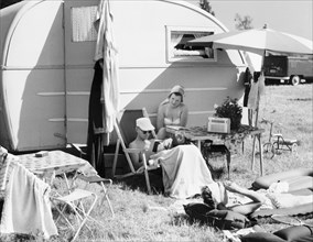 A couple by their caravan at the campsite, Trelleborg, Sweden, 1950s. Artist: Unknown