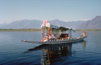 Shikara (traditional wooden boat) on Dal Lake, Srinagar, Kashmir, India.