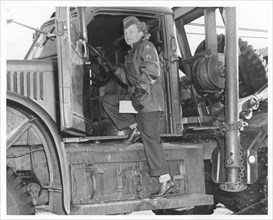 An American WAC sergeant climbing into an army truck, Fort Sheridan, Illinois, USA, 1940s. Artist: Unknown
