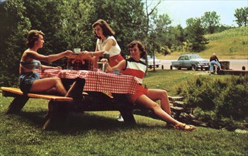 Three young women at a picnic table enjoying a meal, Snowdon, Montreal, Canada, 1955. Artist: Unknown