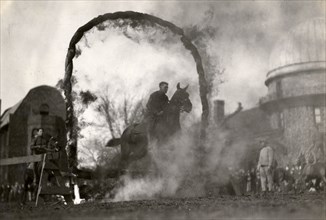 Soldier on horseback jumping through a flaming arch, Fort Sheridan, Illinois, USA, 1920. Artist: Unknown